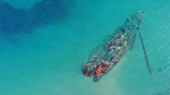 Aerial view of the shipwreck in turquoise water